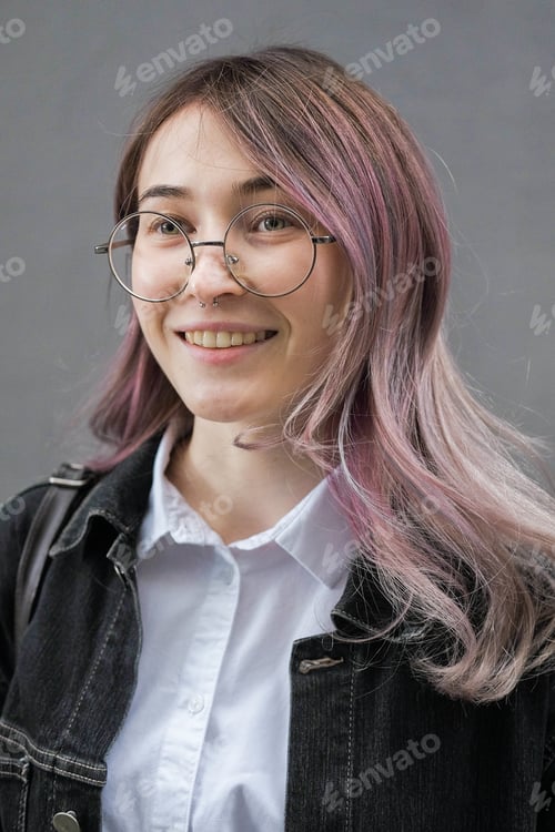 Preview: A Young Woman In A Jeans Jacket, Eyeglasses. Hipster With Purple Colored Head, In Round Glasses On
