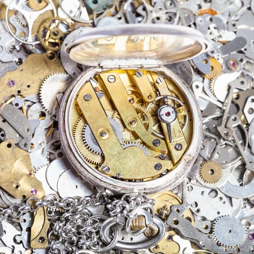 Preview: open retro pocket watch on heap of spare parts