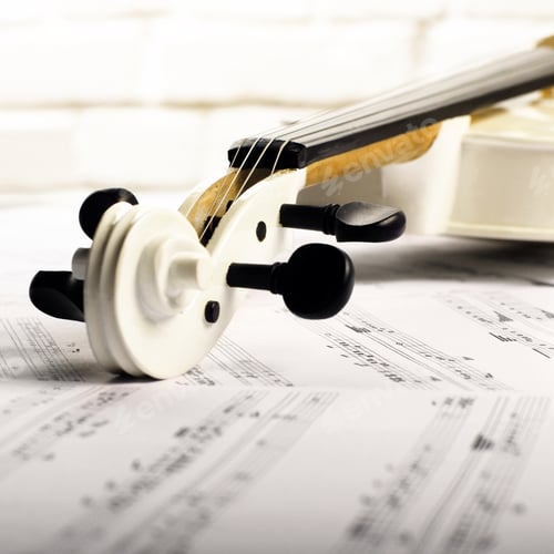 Preview: Close view of a violin and musical notes near white brick wall