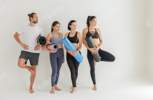 Preview: Group of Yoga Practitioners Poised with Mats Before Class