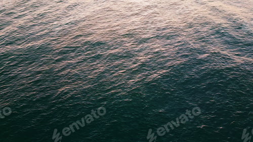 Preview: Closeup sea rippling surface reflecting morning sun. Turquoise water lapping