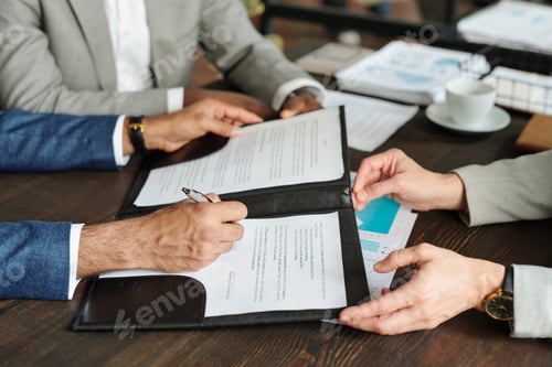 Preview: Caucasian Middle Aged Men Signing Business Contract during Meeting Top View