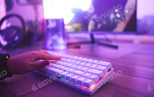 Preview: PC keyboard, gaming and hand for video game, online streaming and gamer room in neon light. Woman o