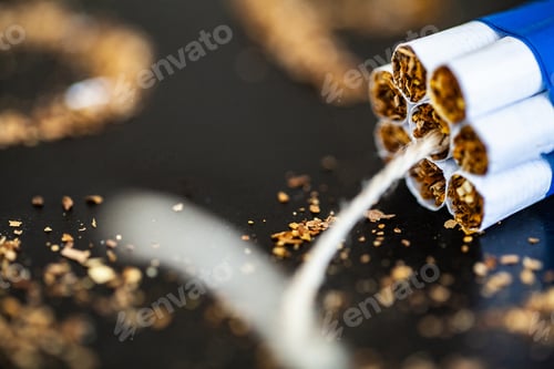 Preview: Stop smoking concept on background with broken cigarettes. Heap of cigarettes. No smoking