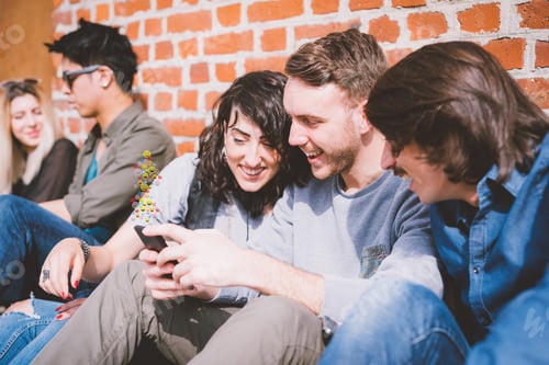 Preview: Group of friends multiethncit sitting outdoor using smart phone