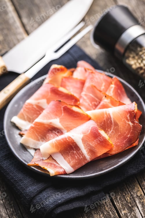 Preview: Sliced schwarzwald ham. Dried prosciutto ham on plate.