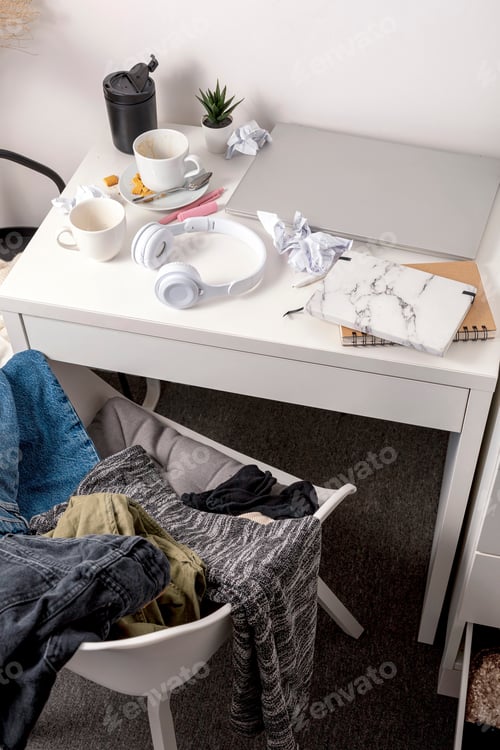 Preview: Messy table with laptop, dirty cups, and stationary items. Cluttered workplace, desk.