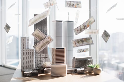 Preview: Paper dollars hundred banknotes falling on architectural scale cardboard model of building complex