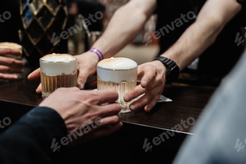Preview: The bartender hands two cocktails to the customer.