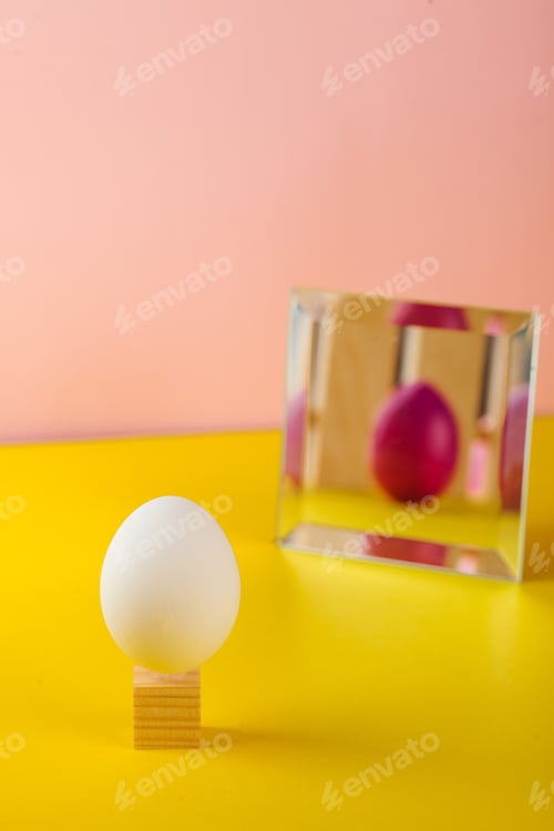 Preview: Easter concept, Easter egg decoration. White egg, in the mirror displaying a colored Easter egg.