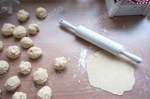 Preview: Hands knead thick dough, roll out with a rolling pin on the kitchen table