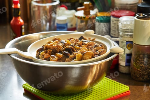 Preview: Oven-fried eggplants settle in sieve on a bowl