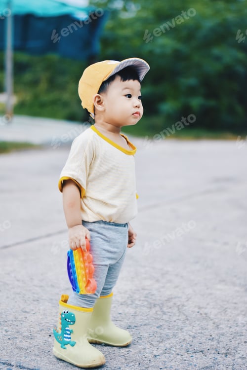 Preview: Little kid boy plays in pop it colorful toy