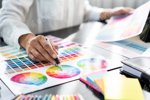 Preview: Young creative graphic designer working on color selection and drawing on graphics tablet