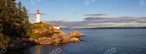 Preview: Lighthouse on a rocky shore during a vibrant cloudy sunset