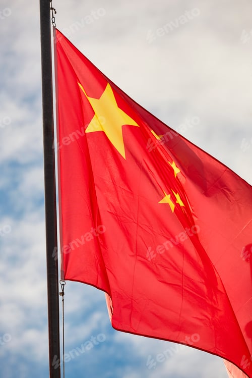Preview: China flag waving over a blue sky. Chinese national emblem
