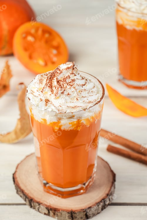 Preview: Spicy latte with pumpkin and whipped cream on wooden background
