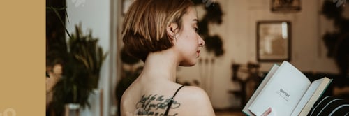 Preview: Woman reading a book at home during coronavirus quarantine