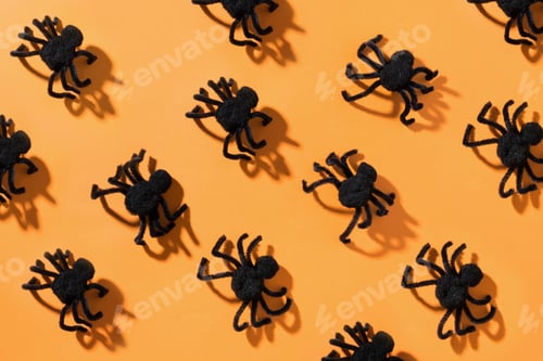 Preview: Black spiders on orange. View from above. Open composition. Halloween party pattern.