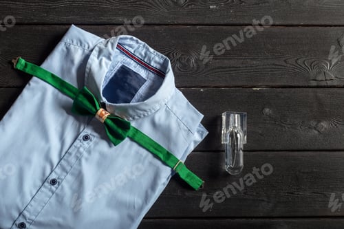 Preview: Shirt with green bow tie and suspenders on wooden table