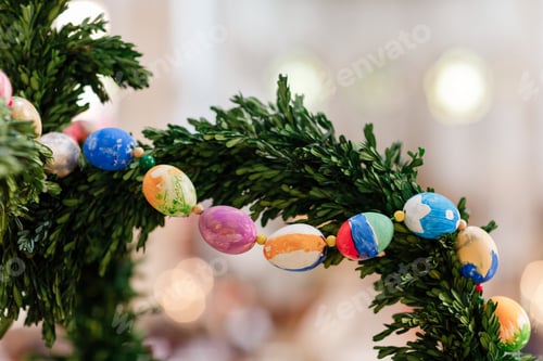 Preview: Green Christmas wreath with decorations on bright background.easter eggs