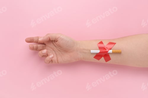 Preview: A Cigarette Glued with a Cross to a Woman's Hand, Quit Smoking Concept.