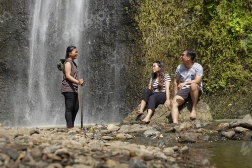Preview: small group of happy young asian people exploring waterfall