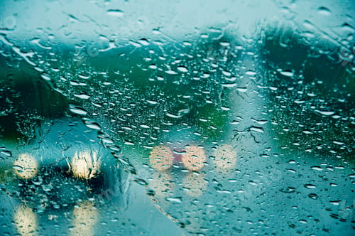 Preview: Rainy day through the windscreen of a car. Road safety. Heavy rainfall