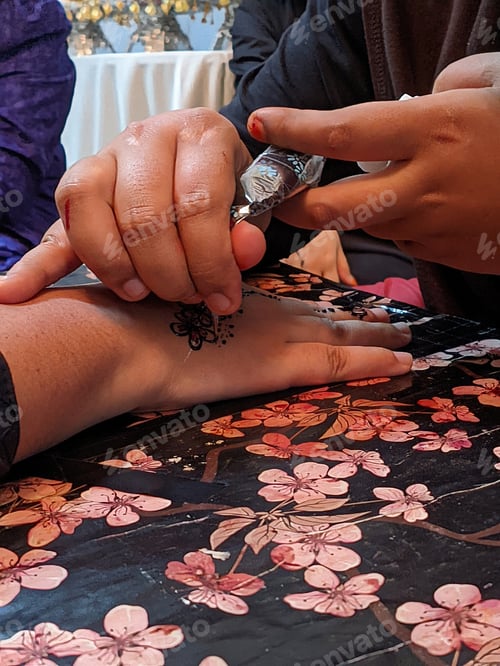 Preview: A hand with intricate henna designs, swirling patterns in reddish-brown, captivating work of art