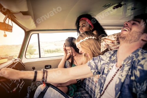 Preview: Happy friends driving a vintage minivan