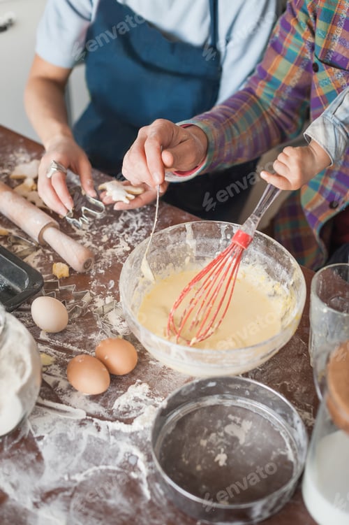Preview: cropped shot of family preparing dough for cookies