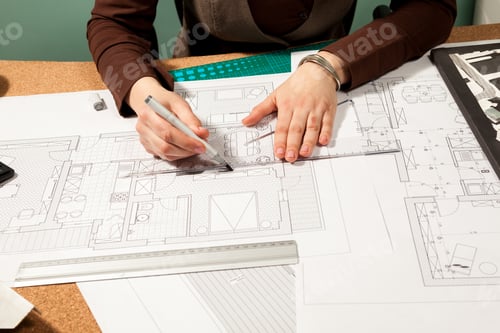Preview: Close up of architect hands working on blueprints