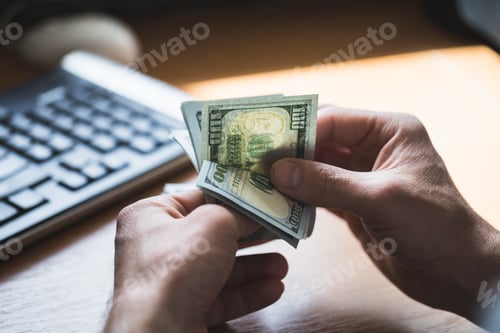 Preview: Businessman is counting dollars banknotes, business and financial background