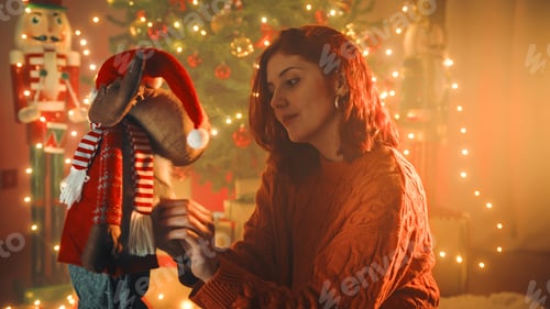 Preview: Girl plays with soft toys under the christmas tree
