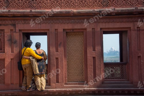 Preview: Romantic Indian couple seeing Taj Mahal from red fort, Agra, India.