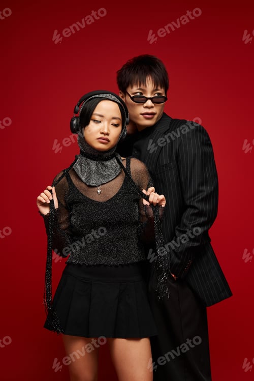 Preview: Stylish couple showcasing love and fashion against a bold red backdrop