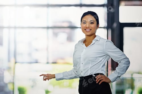 Preview: Portrait of a young businesswoman standing with her hand on her hip in the office