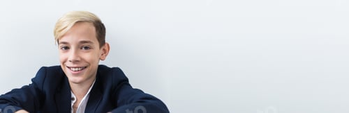 Preview: Banner teen boy with braces on teeth smiling on white. Dentistry and teenager concept.
