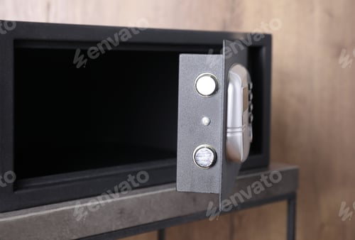Preview: Black steel safe with electronic lock on grey table, closeup