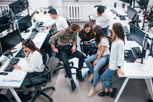 Preview: Young business people working together in the modern office