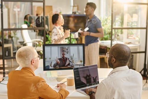 Preview: Programmers talking online with colleague during online meeting