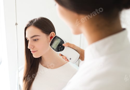 Preview: Woman having ear exam. Tympanometry measures the pressure in the middle ear. Impedance audiometry.