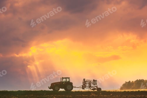 Preview: Tractor On Road In Spring Season. Beginning Of Agricultural Spring Season. Cultivator Mounted On