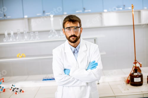 Preview: Young scientist in white lab coat standing in the biomedical lab