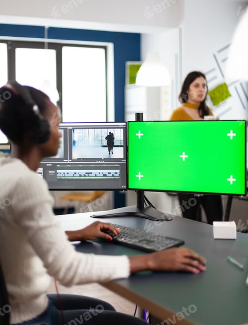 Preview: African woman multimedia content creator with headphones processing film montage