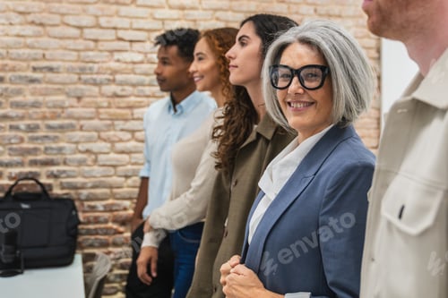 Preview: Diverse business professionals smiling in a coworking space