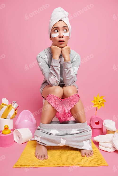 Preview: Pensive Asian woman has surprised expression wears pajama towel wrapped on head beauty patches under