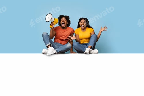 Preview: Emotional black couple sitting on empty horizontal board for advertisement