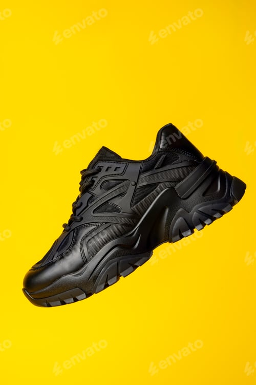 Preview: Black new sport sneakers on yellow background
