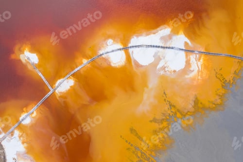 Preview: Abstract aerial pattern of toxic orange mining industry residuals, waste water, by drone